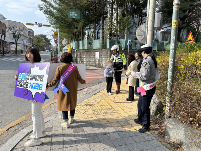 12일 오전 강원 춘천시 신남초등학교 앞에서 춘천경찰서, 도로교통공단 강원지부, 모범운전자회 등 30여명이 어린이 교통안전 의식 확산을 위한 등굣길 어린이 교통안전 캠페인을 진행하고 있다. <연합뉴스>